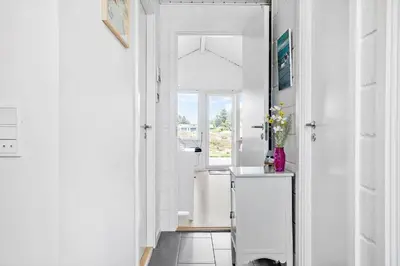 a hallway with a door leading to a bathroom with a sink at 447-Thisted-Kuttervej-13 in Thisted