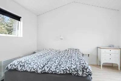 a white bedroom with a bed and a window at 447-Thisted-Kuttervej-13 in Thisted