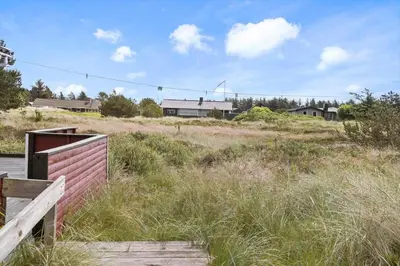 a field of tall grass with houses in the background at 240-Thisted-Hummervej-10 in Thisted