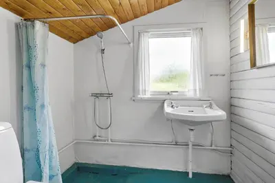 a white bathroom with a sink and a shower at 240-Thisted-Hummervej-10 in Thisted