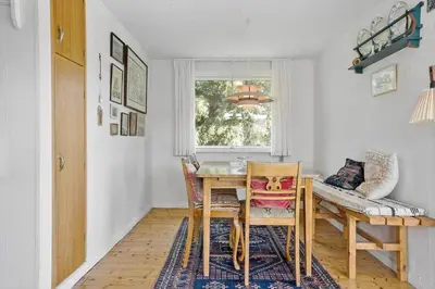 a dining room with a table and chairs and a window at 240-Thisted-Hummervej-10 in Thisted