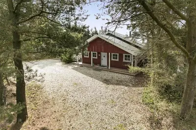 a red cabin in the middle of a forest at 929-Thisted-Brandisvej-19 in Torsted