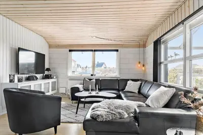 a living room with a leather couch and a tv at 670-Thisted-Krebsvej-4 in Thisted