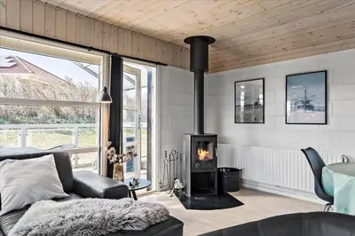 a living room with a fireplace and a couch at 670-Thisted-Krebsvej-4 in Thisted