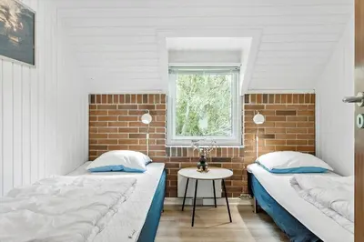 two beds in a room with a window and a table at 479-Thisted-Kristinesvej-36 in Thisted