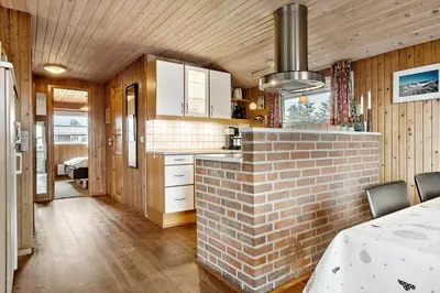 a kitchen with a brick fireplace in a room at 533-Thisted-Fiskervej-153 in Thisted