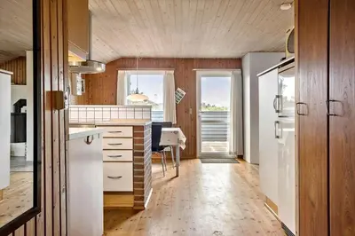 a kitchen with a white refrigerator and a table at 533-Thisted-Fiskervej-153 in Thisted