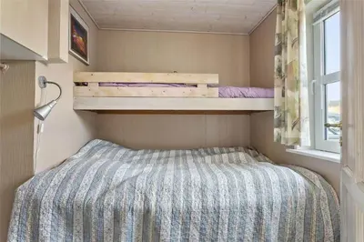 a small bedroom with a bed and a window at 581-Thisted-Nordsovej-32 in Thisted