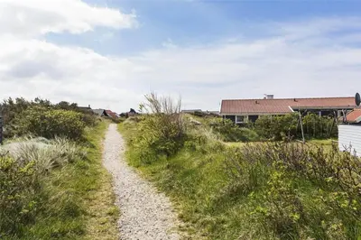 a gravel path through a field with a house at 581-Thisted-Nordsovej-32 in Thisted