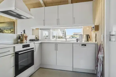a white kitchen with white cabinets and a window at 796-Snedsted-Somaerkevej-66 in Snedsted