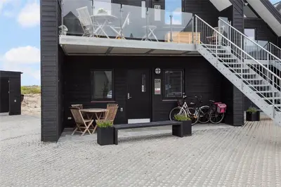 a house with a staircase and a table and chairs at 785-Thisted-Havstokken-32-A in Thisted