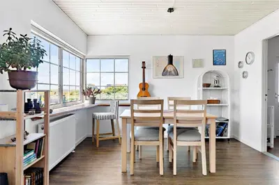 a dining room with a table and chairs and windows at 204-Vestervig-Lodbjergvej-4 in Vestervig