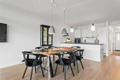 a kitchen and dining room with a wooden table and chairs at 784-Thisted-Havstokken-30-A in Thisted