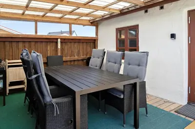 a wooden table and chairs on a patio at 787-Thisted-Nordsovej-38 in Thisted