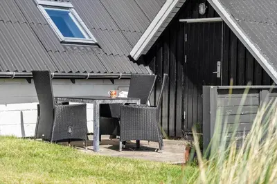 a table and chairs in front of a house at 580-Thisted-Gaeslingevej-5 in Thisted