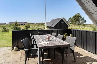 a wooden table and chairs on a patio at 580-Thisted-Gaeslingevej-5 in Thisted