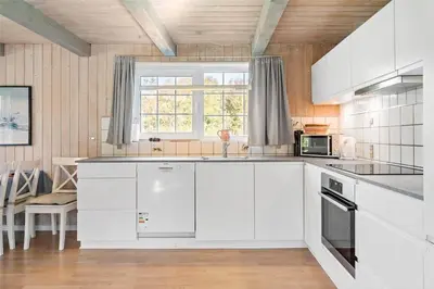 a kitchen with white cabinets and a window at 517-Thisted-Sigvej-10 in Thisted