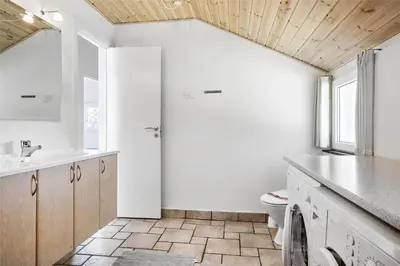 a white bathroom with a toilet and a sink at 542-Thisted-Kuttervej-11 in Thisted