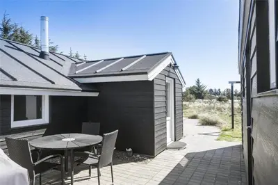 a patio with a table and chairs and a building at 542-Thisted-Kuttervej-11 in Thisted
