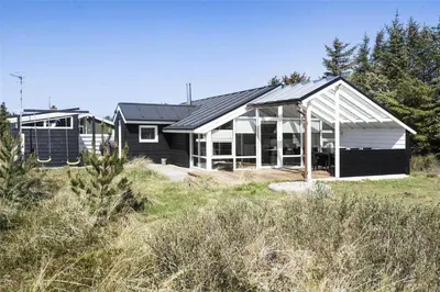 a black and white house in the middle of a field at 542-Thisted-Kuttervej-11 in Thisted