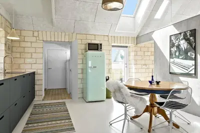 a kitchen with a table and a blue refrigerator at 758-Vestervig-Vesterhavsvej-28 in Vestervig