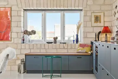 a kitchen with a counter with a stool and two windows at 758-Vestervig-Vesterhavsvej-28 in Vestervig