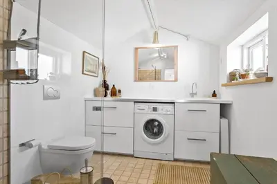 a white bathroom with a washing machine and a sink at 758-Vestervig-Vesterhavsvej-28 in Vestervig