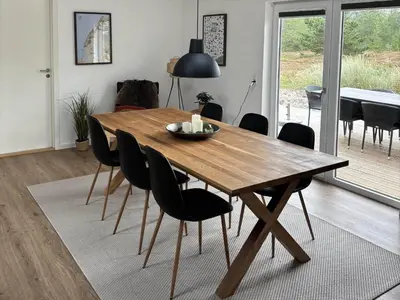 a wooden table and chairs in a living room at 162-Thisted-Molgaardsvej-62 in Thisted