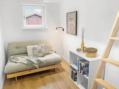 a living room with a couch and a book shelf at 162-Thisted-Molgaardsvej-62 in Thisted
