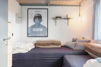 a bed in a room with a picture on the wall at 1012-Thisted-Trindbak-12-B in Torsted