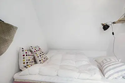 a white bed in a white room with pillows at 1012-Thisted-Trindbak-12-B in Torsted
