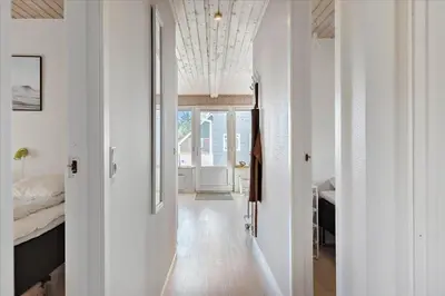 a hallway with a bed and a room with white walls at 716-Thisted-Kristinesvej-34 in Thisted
