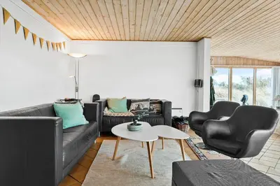 a living room with two black leather chairs and a table at 529-Thisted-Nordsovej-24 in Thisted