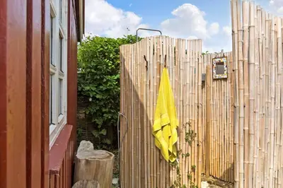 a yellow umbrella hanging on a wooden fence at 531-Thisted-Ingerslevvej-5 in Thisted