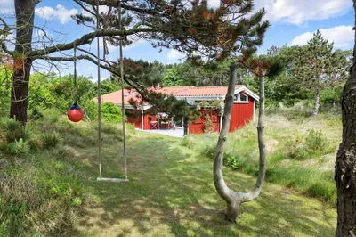 a swing in a yard with a red house at 531-Thisted-Ingerslevvej-5 in Thisted