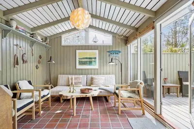 a screened in porch with a couch and a table at 531-Thisted-Ingerslevvej-5 in Thisted