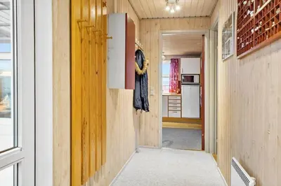 a hallway with wood paneled walls and a door at 860-Thisted-Gronnevej-6 in Thisted