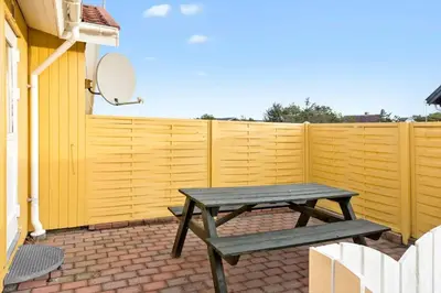 a picnic table in front of a yellow fence at 860-Thisted-Gronnevej-6 in Thisted