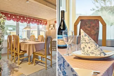 a dining room with a table and a bottle of wine at 860-Thisted-Gronnevej-6 in Thisted