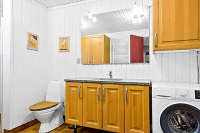 a bathroom with a toilet and a sink and a washing machine at 860-Thisted-Gronnevej-6 in Thisted