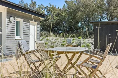 a patio with a table and chairs in front of a house at 151-Thisted-Havbovej-39 in Thisted