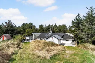 a house on top of a hill with trees at 713-Thisted-Tranebaervej-10 in Thisted