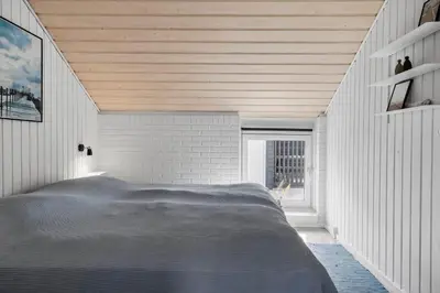 a bedroom with a large bed in a white room at 382-Thisted-Kristinesvej-2 in Thisted