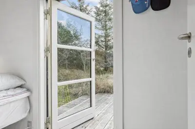 an open door with a window in a bedroom at 1309-Thisted-Blabaervej-2 in Thisted