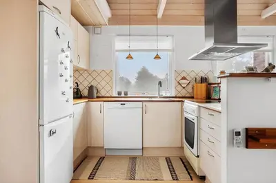 a kitchen with white appliances and a window at 1332-Thisted-Flyndervej-22 in Thisted