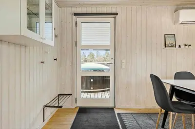 a dining room with a door and a table and chairs at 1322-Snedsted-Lykkens-Hab-21 in Snedsted
