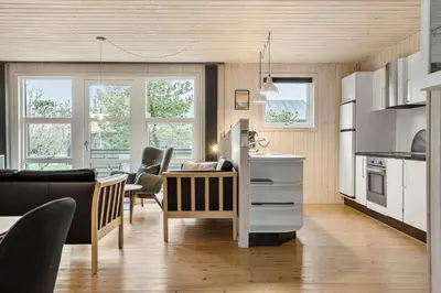a kitchen and living room with a table and chairs at 1322-Snedsted-Lykkens-Hab-21 in Snedsted