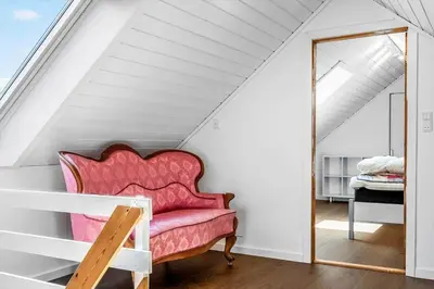 a pink chair in a room with a mirror at 1329-Thisted-Nordsovej-226 in Thisted