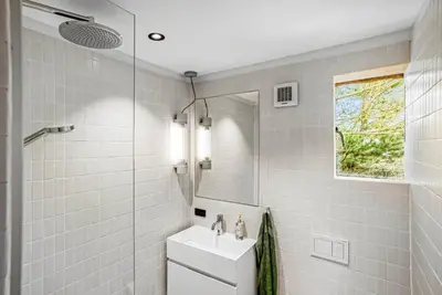 a white bathroom with a sink and a mirror at 1061-Thisted-Spanggardsvej-85-B in Torsted