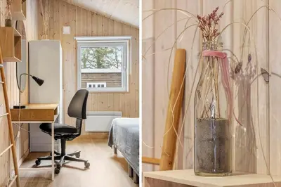 a room with a desk and a vase with flowers in it at 1341-Thisted-Mose-Bolle-Vej-5 in Thisted